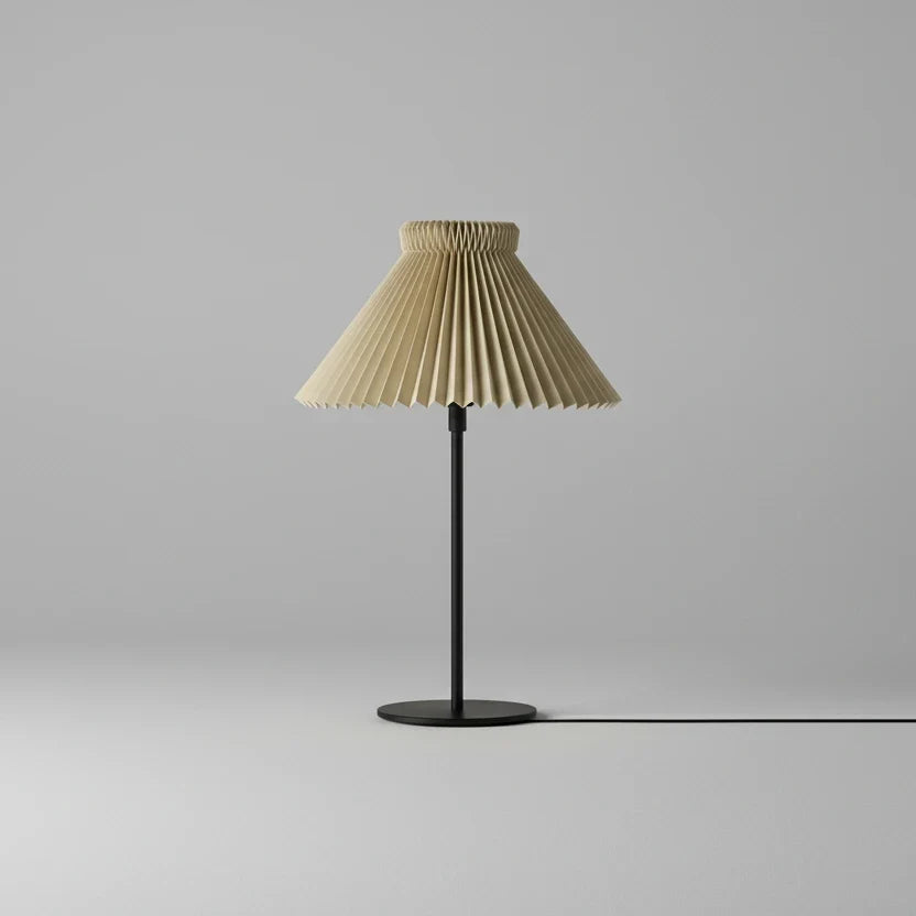 Table lamp with pleated beige shade on a gray background