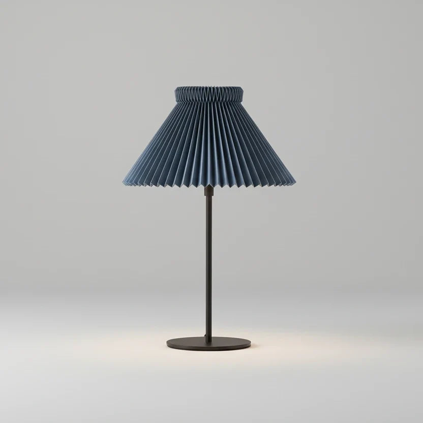 Table lamp with pleated blue shade on a white background
