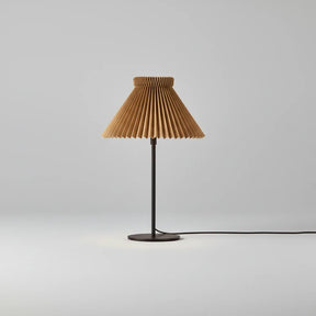 Table lamp with pleated brown shade on a white background