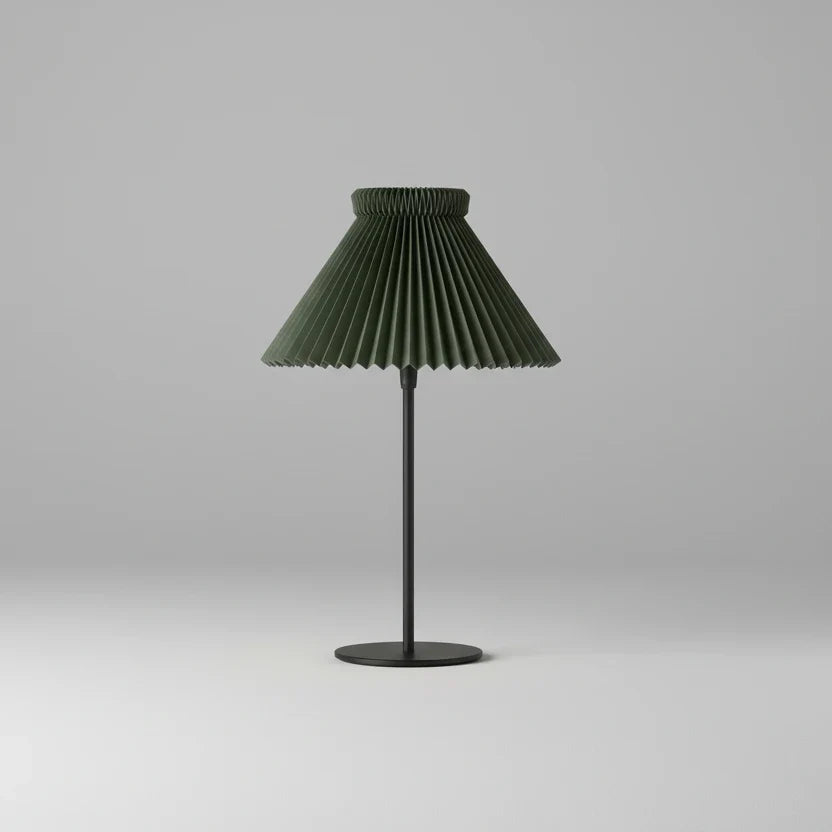 Table lamp with pleated green shade on a gray background